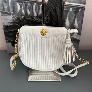 This bag is so pretty and elegant. On the back side there is a small scratch.